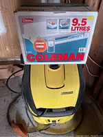 Yellow and black Karcher power washer with Coleman cooler box on top