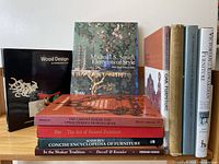 Photo showing the ten furniture-related books stacked and standing upright for display.