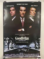 Full view of Goodfellas movie poster showing main actors and street scene.