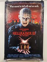 Full front view of Hellraiser III: Hell on Earth movie poster showing Pinhead holding puzzle box with tagline and cityscape background.
