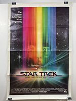 Full view of the Star Trek The Motion Picture movie poster with rainbow light beams and character images.