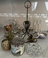 Photo showing assortment of votive, tea light, crystal, brass holders, and Bath & Body Works candle