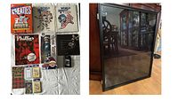 All items arranged on table with framed jersey case leaning.