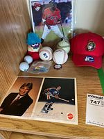 Overall view of all items on shelf showing Wayne Gretzky photo, toddler hats, baseballs, golf balls, and toys