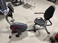 Side view of the Health Rider H22X recumbent exercise bike showing seat, pedals, and digital screen.