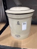 Front view of large off-white stoneware crock with lid, showing 5 Imperial and Medalta Potteries Ltd marks and some aged wear.