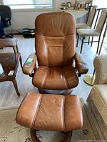 Front view of chair and ottoman showing full set and wood base