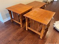Pair of oak wood side tables in Mission style showing front and side views on hardwood floor.