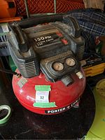 Full view of the Porter Cable air compressor showing control panel, gauges, and handle.