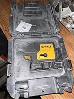 Close-up photo showing the DeWalt electronic leveler housed inside a black plastic carrying case.