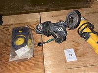Overall view showing IRWIN circle cutter in packaging, Makita power drill, and yellow angle grinder on wooden surface.