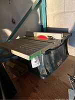 Full side view of the Ryobi RTS10 table saw showing the blade, table surface, and body of the saw.