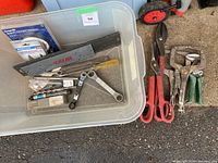 Photo of assorted sheet metal tools in a plastic bin including snips, wrenches, measuring tape, and magnetic protector.