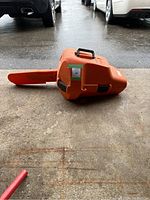 Orange STIHL plastic protective case closed with bar scabbard attached
