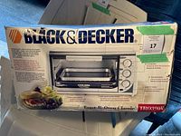 Original sealed box of Black & Decker Toast-R-Oven Classic toaster oven model TR0300W showing product image and details.