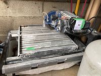 Full view of wet saw on water tray in garage