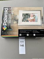 Polaroid 7-inch digital picture frame box showing product image, features, and branding.