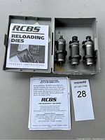 Plastic case containing three RCBS metallic reloading dies and instruction manuals.