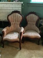 Pair of Victorian style chairs with brocade upholstery and carved wooden frames shown side by side in a living room setting.