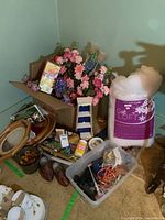 Whole lot overview showing faux flowers, fiber fill, wooden shoes, floral foam, decorative beads, and framed plates.