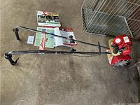 Overall view of Mantis tiller/cultivator laid out on concrete floor with operator’s manual