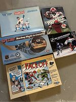 Five vintage sports-themed board games displayed together, showing titles and box artwork.