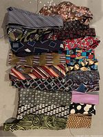 Photo showing all 18 vintage silk ties in various patterns and colors, arranged side by side for display.