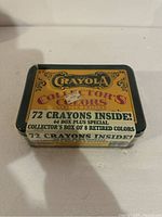 Top and side view of sealed vintage Crayola collector's tin featuring 72 crayons including 64 regular and 8 retired colors