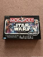 Closed box of Star Wars Monopoly Original Trilogy Edition showing cover art with characters and ships from the Star Wars trilogy.