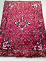 Full top view of the rug laid flat showing central medallion and border patterns