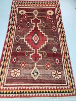 Full view of rug laid flat showing overall design and color palette