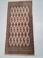 Full view of the hand-knotted Turkman wool rug showing overall pattern and color.