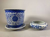 Ceramic blue and white planter next to porcelain dragon shallow bowl, showing overall lot content