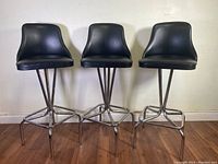 Three stools front view showing seat shape and base design