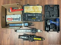 All tools shown together including power drill, wrench, sway controllers, jacks, and socket set