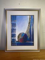 Overview of the framed lithograph image with abstract design and silver gold frame