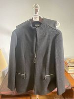 Front view of black textured wool/cashmere Giorgio Armani jacket with zip closure and zippered pockets