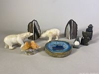 Wide view of all items including geode bookends in the back and carved animals and a geode slice in front.