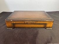 Closed wooden chest with minor wear and some surface scratches, chest dimensions approximately 17x11x4 inches.