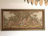 Full view of the framed tapestry showing the entire pastoral scene with multiple figures, animals, and landscape.