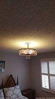 Photo of the lit ceiling mounted light fixture showing its size and placement in the room.