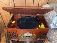 Top view of open Electrohome music player showing the turntable and tonearm inside a wooden case.