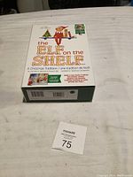 The original closed box of 'The Elf on the Shelf' Christmas collectible with visible branding and illustrations on top.