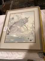 Framed art print depicting a lynx in a snowy landscape, matted and framed under glass.