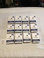 Twelve neatly stacked boxes labeled Pencil Buddies Golf Pencils with boxes showing product branding.