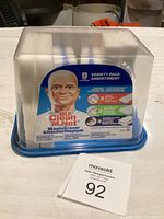 Front view of the Mr. Clean Magic Eraser variety pack inside a clear plastic container with a blue base and lid.