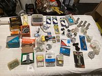 Overview of all fasteners and hardware items spread on table including various boxed brands and loose items