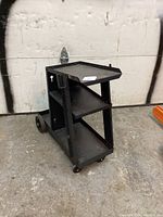 Front and side view of Mastercraft metal welding cart with shelves and wheels