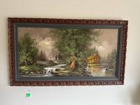 Full view of the framed landscape painting showing the cabin, river, and forest scenery.