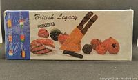 Front angle showing factory sealed box of British Legacy Essentials knives with colorful food images and knife block illustration.
